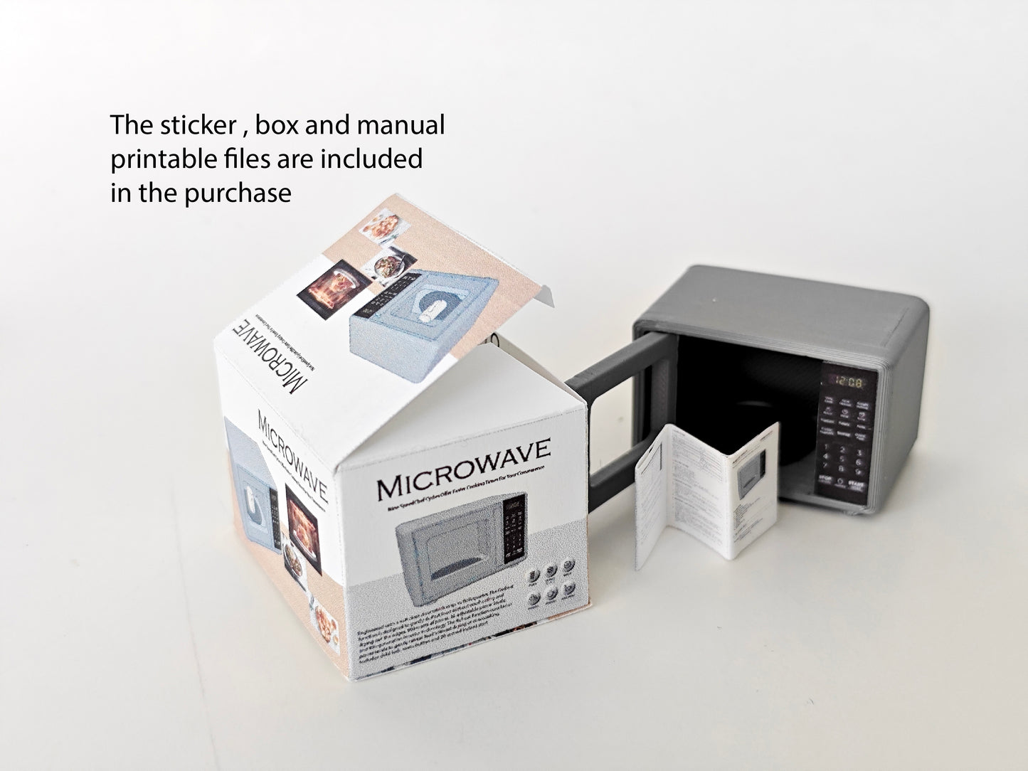 A 1:12 scale 3D-printed dollhouse kitchen setup featuring an openable microwave, mini cookware, and a pot, accompanied by a printable box and manual, arranged to create a detailed miniature cooking scene for diorama or dollhouse enthusiasts.