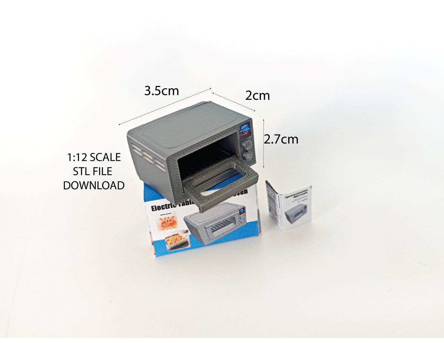A 1:12 scale 3D-printed dollhouse kitchen setup featuring a toaster oven, mini cookware, and a pot, accompanied by a printable box and manual, arranged to create a detailed miniature cooking scene for diorama or dollhouse enthusiasts.
