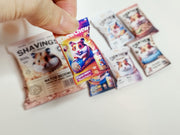 A digital preview of a printable 1:6 scale miniature template kit for dollhouse hamster pet accessories. The kit showcases 7 styles, including colorful hamster food bags, snack packets, wooden chip piles, and cozy pet bedding, arranged for a charming dollhouse pet scene.

