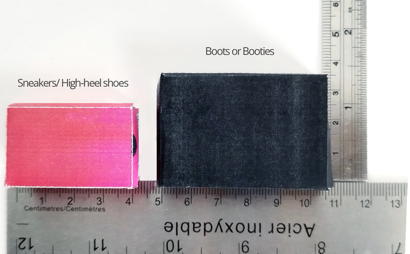 Pink and black miniature doll shoe boxes measured by a metal ruler.