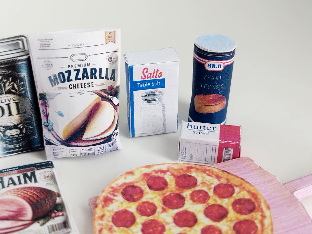 Dollhouse scene featuring 1:6 scale miniature pizzas and boxes in a pizza shop or grocery store setting