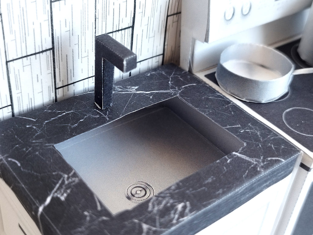 A digital printable template for a 1:12 scale dollhouse mini kitchen sink, designed for BMM system dollhouse setups. The template features a detailed, modern kitchen sink with a sleek faucet, ready to be printed on regular paper, cut, and assembled for a miniature kitchen scene.

