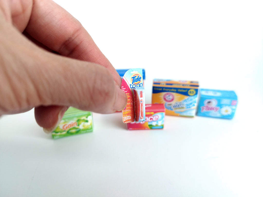 Explore 1:6 and 1:12 scale miniature laundry products for dolls and Barbie dollhouse laundry rooms. Discover 7 unique styles of detergents and accessories, perfect for creating a detailed, realistic miniature project.