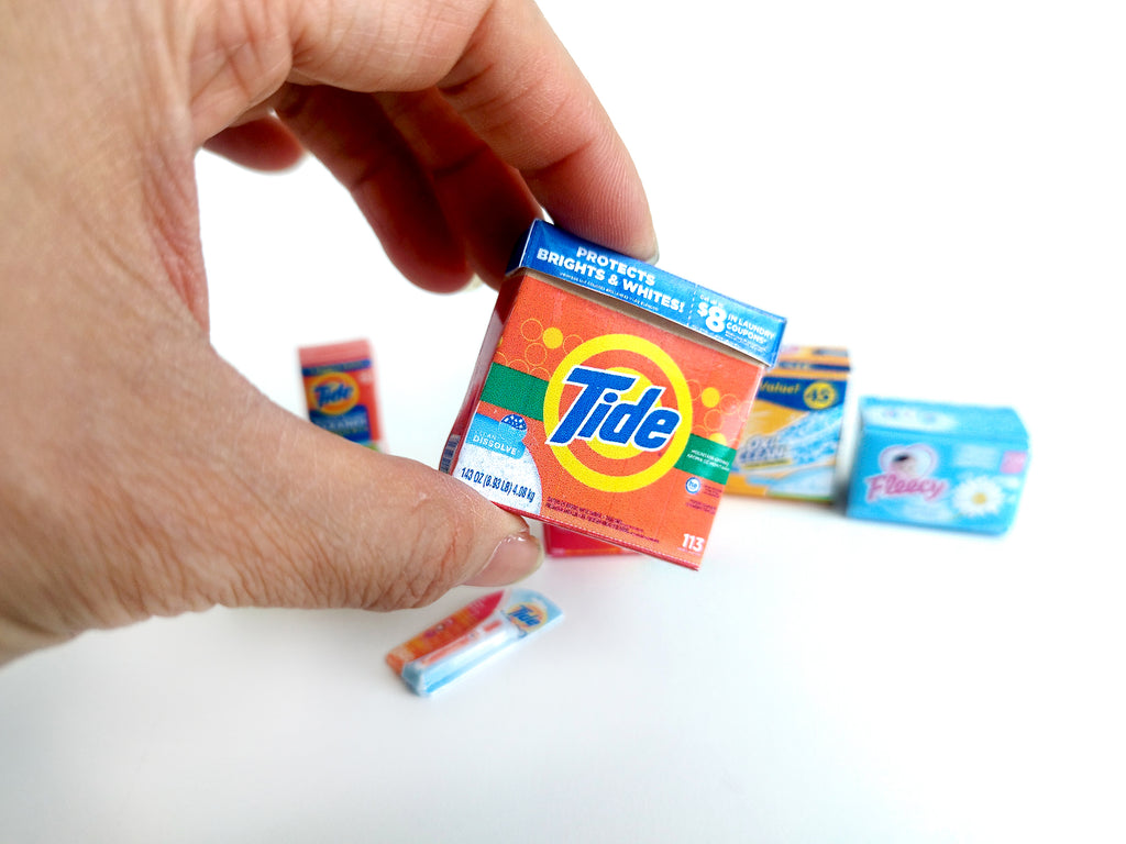 Explore 1:6 and 1:12 scale miniature laundry products for dolls and Barbie dollhouse laundry rooms. Discover 7 unique styles of detergents and accessories, perfect for creating a detailed, realistic miniature project.