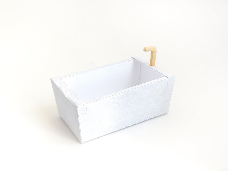 A digital printable template for a 1:12 scale dollhouse bathtub, designed for BMM shoe box bathroom scenes. The template features a detailed, elegant bathtub with clean lines, ready to be printed on regular paper, cut, and assembled for a miniature bathroom setup.