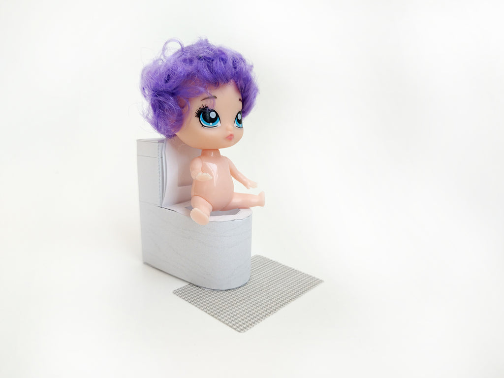 A digital printable template for a 1:12 scale dollhouse white toilet and matching carpet, designed for BMM shoe box bathroom scenes. The template includes a detailed, modern white toilet and a textured carpet, ready to be printed on regular paper, cut, and assembled for a miniature bathroom setting.

