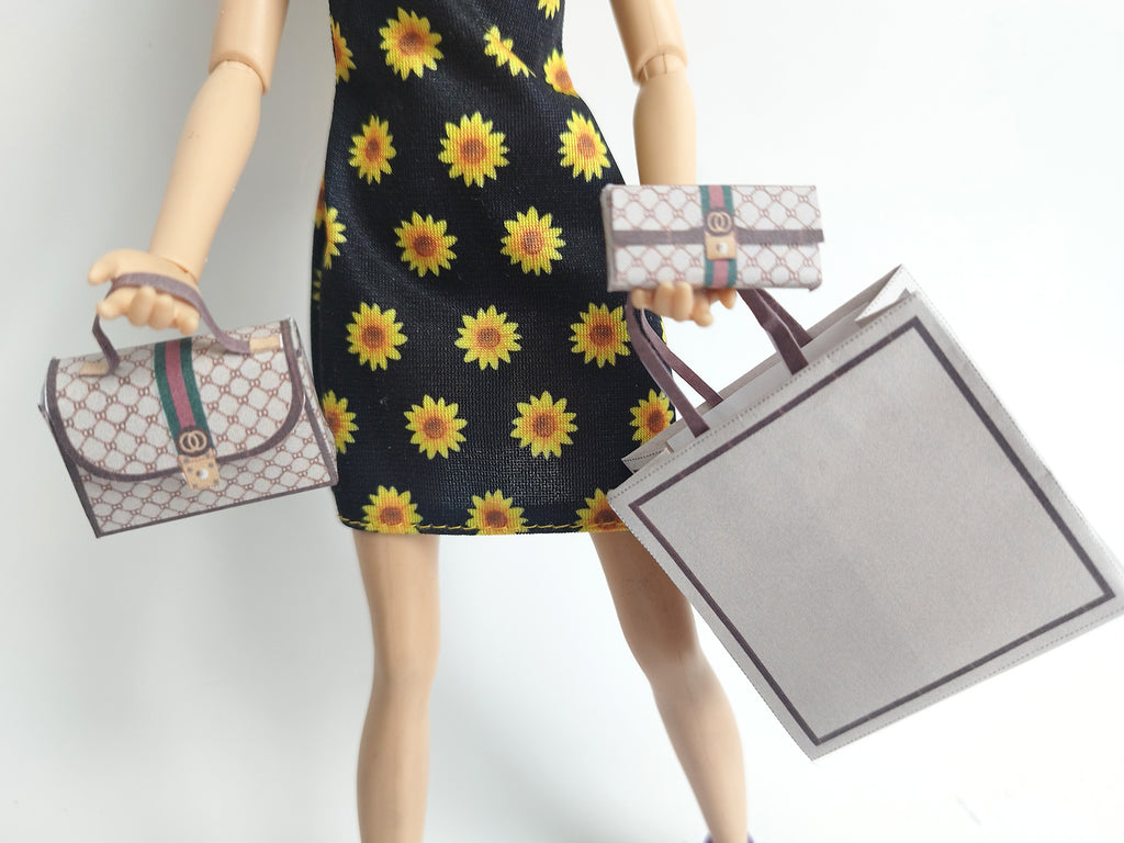 A 1:6 scale printable dollhouse set featuring four luxury brand-inspired brown shopping bags, a purse, and boxes, designed for department store or luxury home decor dioramas, ideal as yearly ornaments for miniature scenes.
