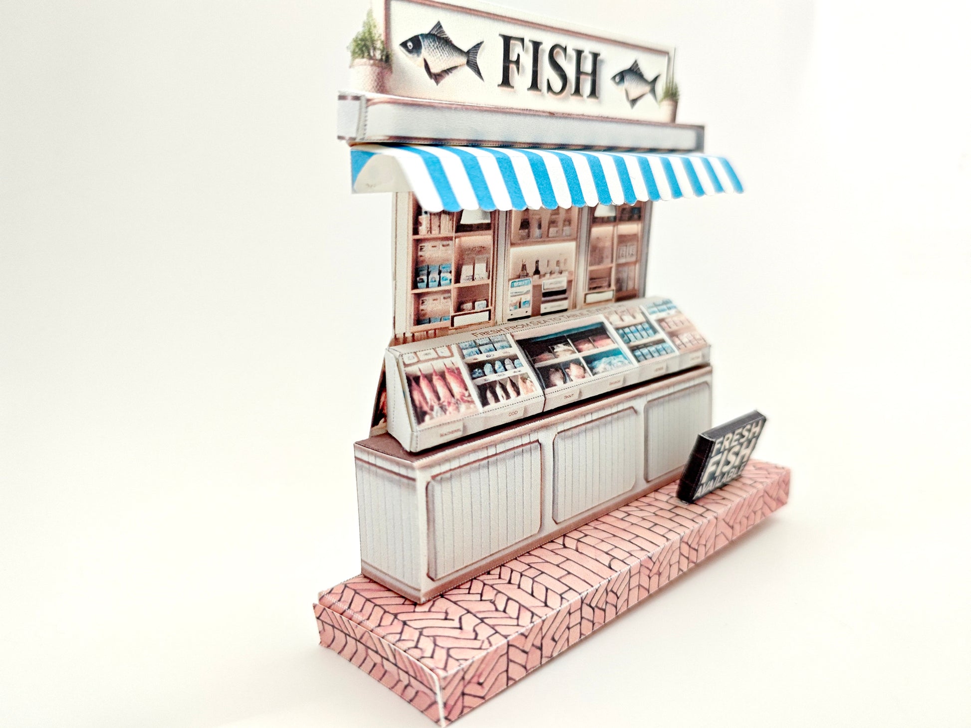 Whether as a wall decoration or a heartfelt gift, this customizable template lets you create a personalized tribute to the charm of a fish shop stand. Perfect for any occasion, this printable template brings creative 3D design to life in the form of a delightful fish shop stand miniature. Download and personalize it for those who appreciate the unique charm of a bustling fish mar