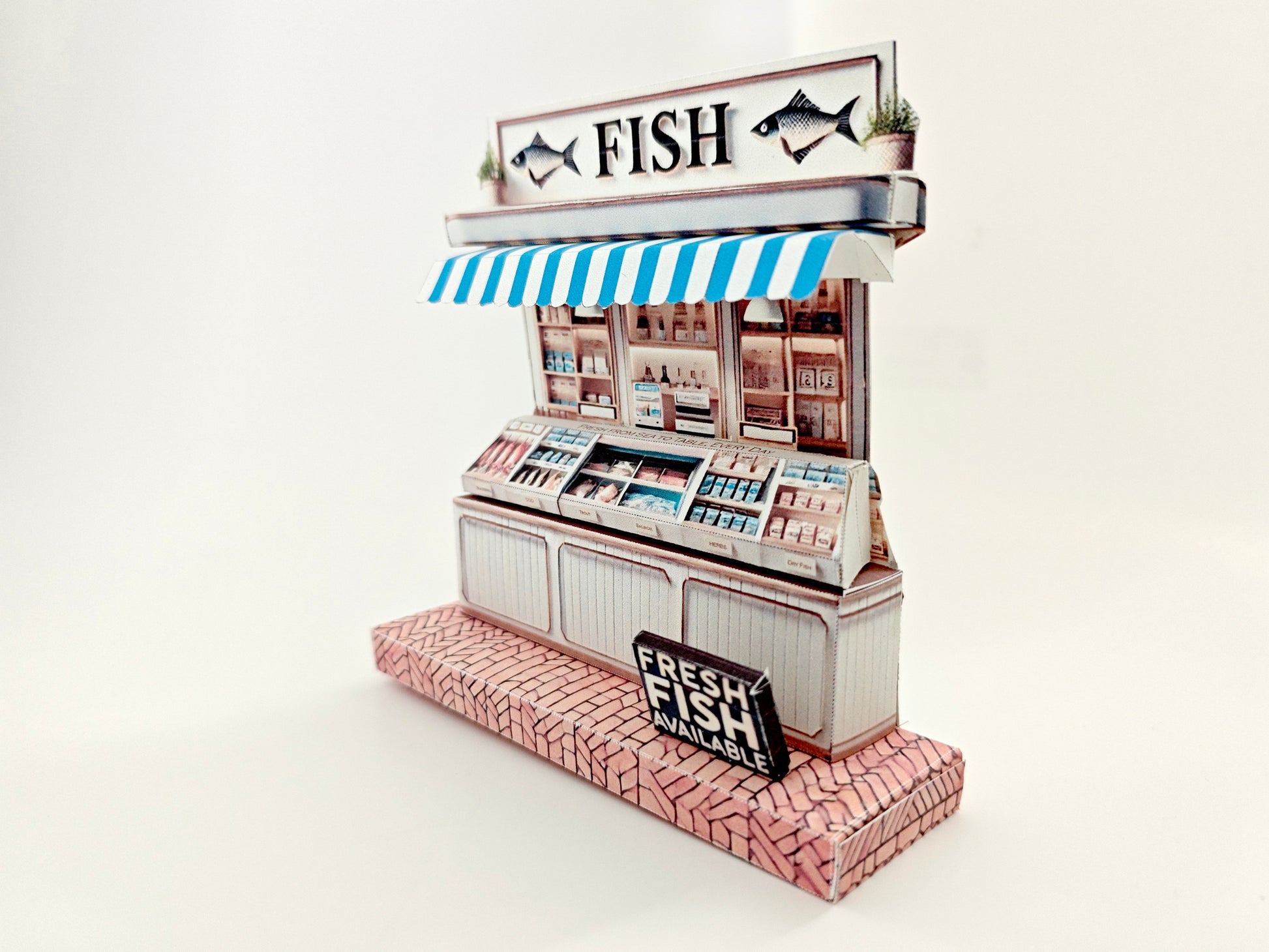 Whether as a wall decoration or a heartfelt gift, this customizable template lets you create a personalized tribute to the charm of a fish shop stand. Perfect for any occasion, this printable template brings creative 3D design to life in the form of a delightful fish shop stand miniature. Download and personalize it for those who appreciate the unique charm of a bustling fish mar