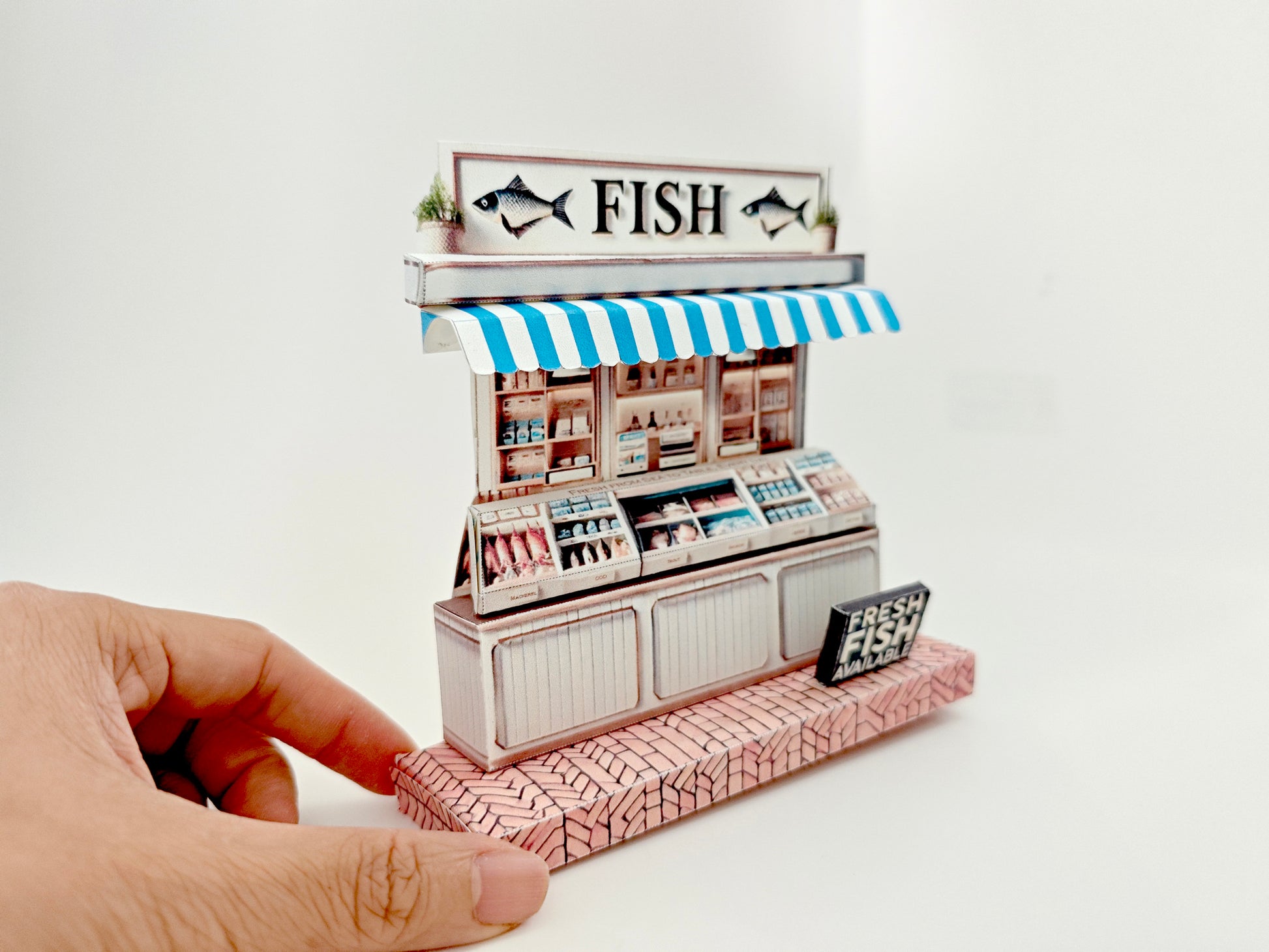 Whether as a wall decoration or a heartfelt gift, this customizable template lets you create a personalized tribute to the charm of a fish shop stand. Perfect for any occasion, this printable template brings creative 3D design to life in the form of a delightful fish shop stand miniature. Download and personalize it for those who appreciate the unique charm of a bustling fish mar
