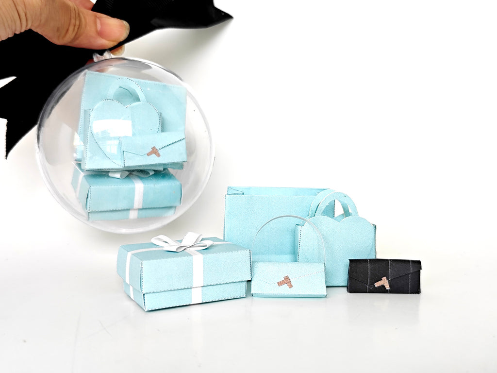Enhance your dollhouse or department store with this 1:6 scale 5-item Sea Blue Purse and Gift Box set in black and sea blue tones. Ideal as a yearly ornament, perfect for stylish miniature displays and collectors