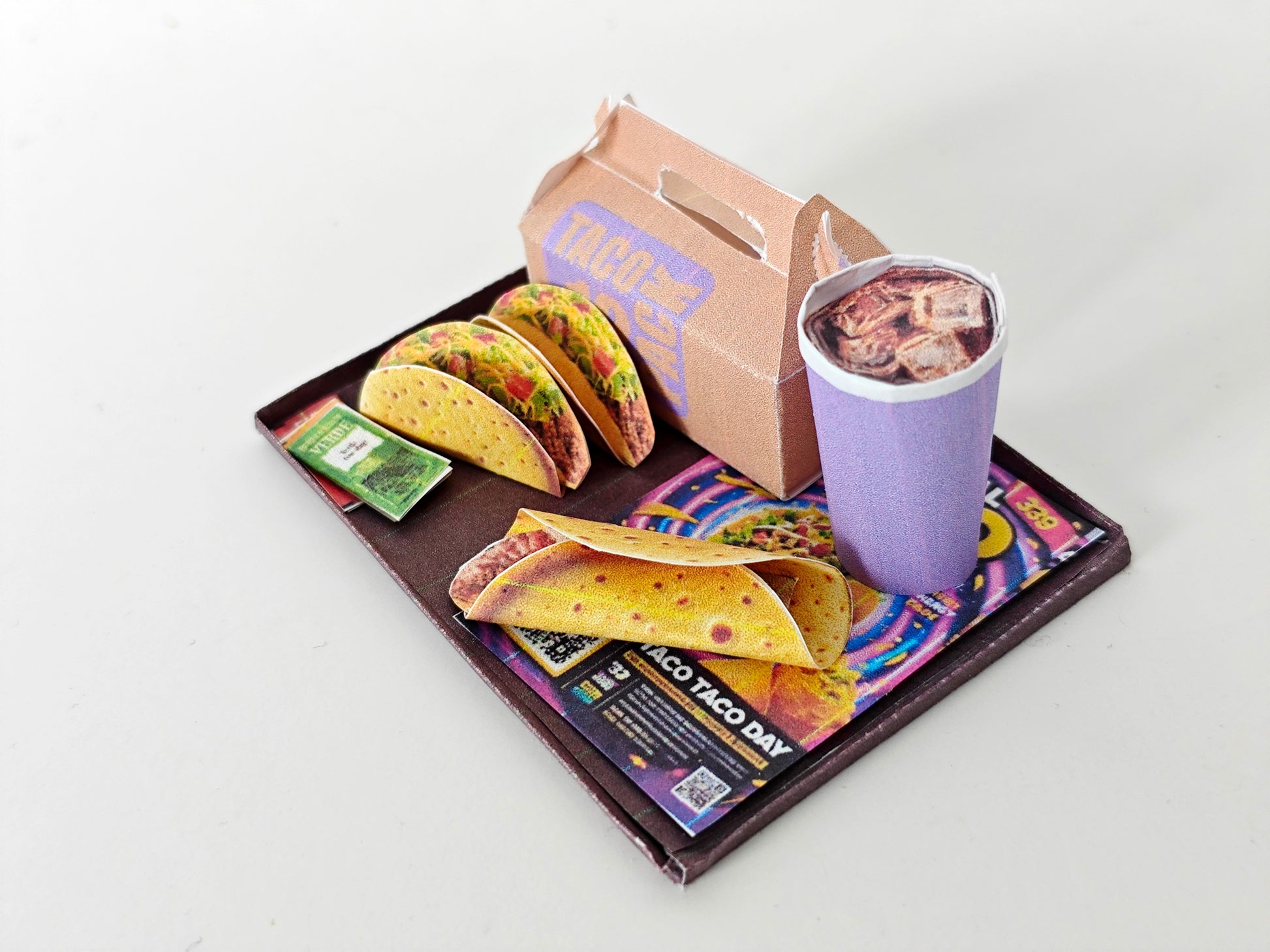 A 1:12 scale printable dollhouse fast food set featuring a taco wrap and soda, crafted as DIY templates for miniature dining scenes or yearly ornaments, ideal for detailed diorama customization.