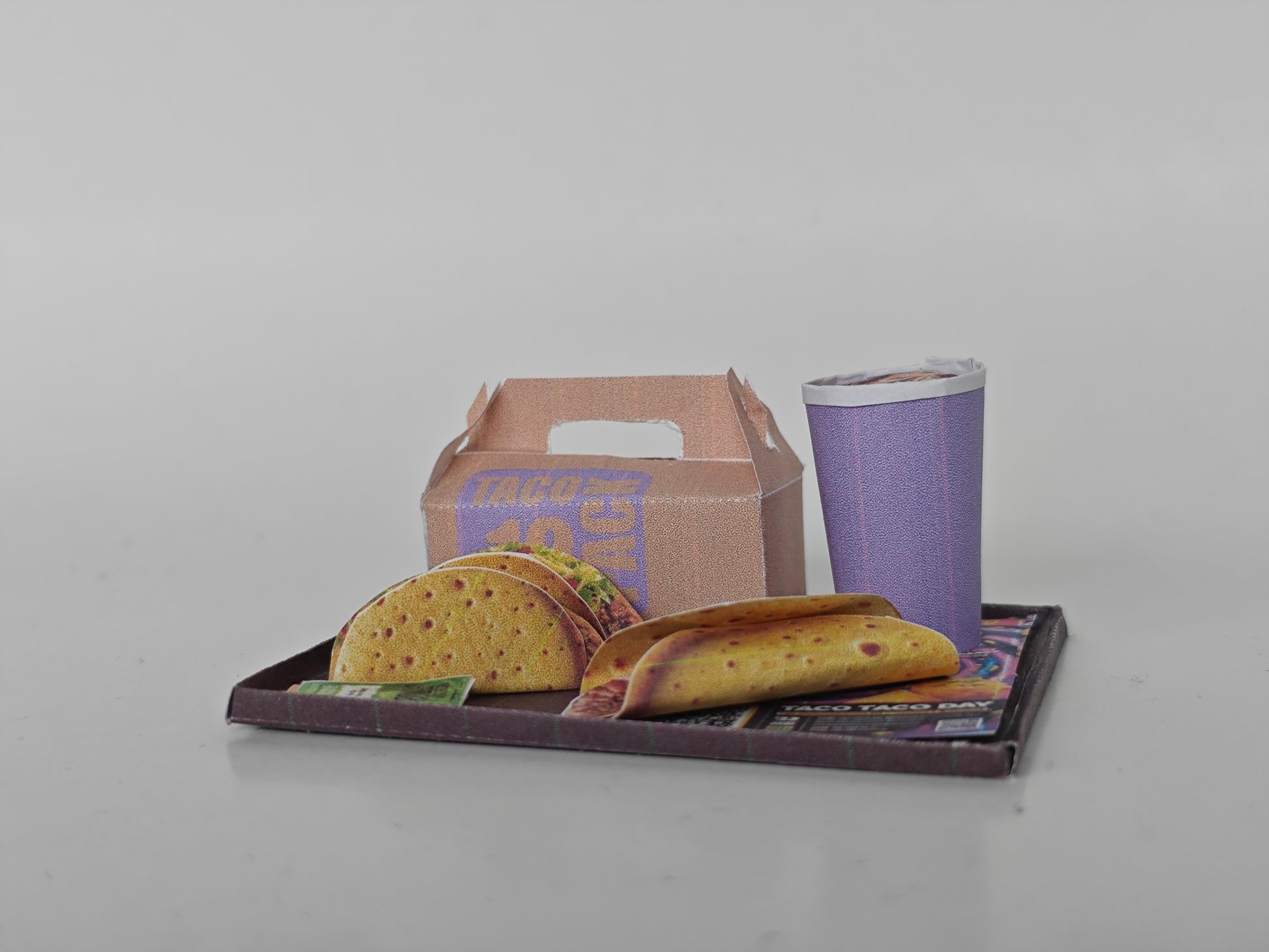 A 1:12 scale printable dollhouse fast food set featuring a taco wrap and soda, crafted as DIY templates for miniature dining scenes or yearly ornaments, ideal for detailed diorama customization.