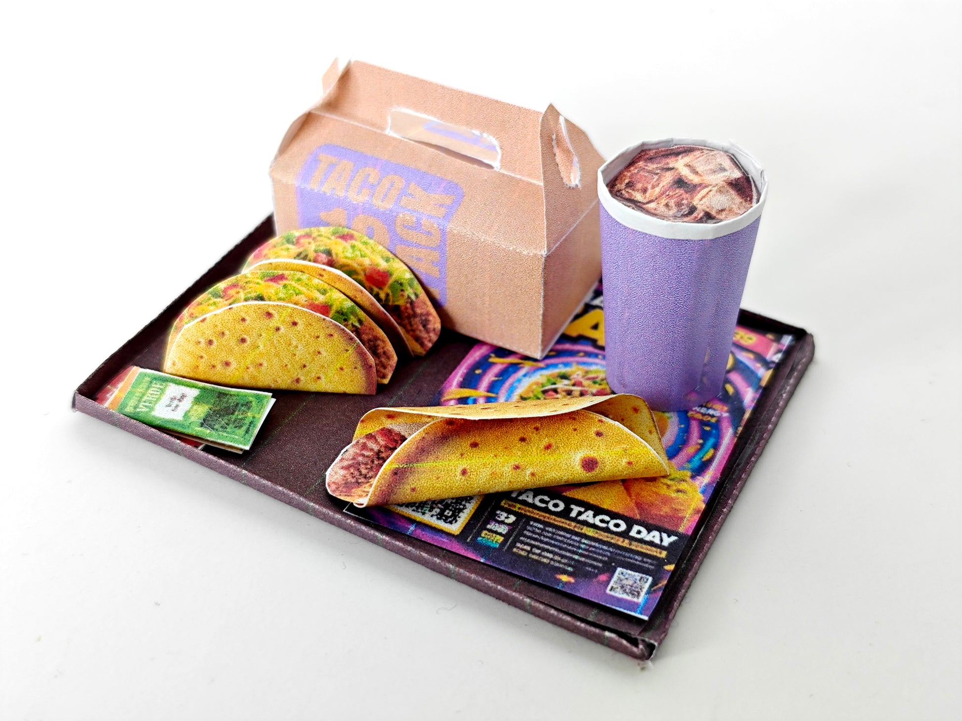 A 1:12 scale printable dollhouse fast food set featuring a taco wrap and soda, crafted as DIY templates for miniature dining scenes or yearly ornaments, ideal for detailed diorama customization.