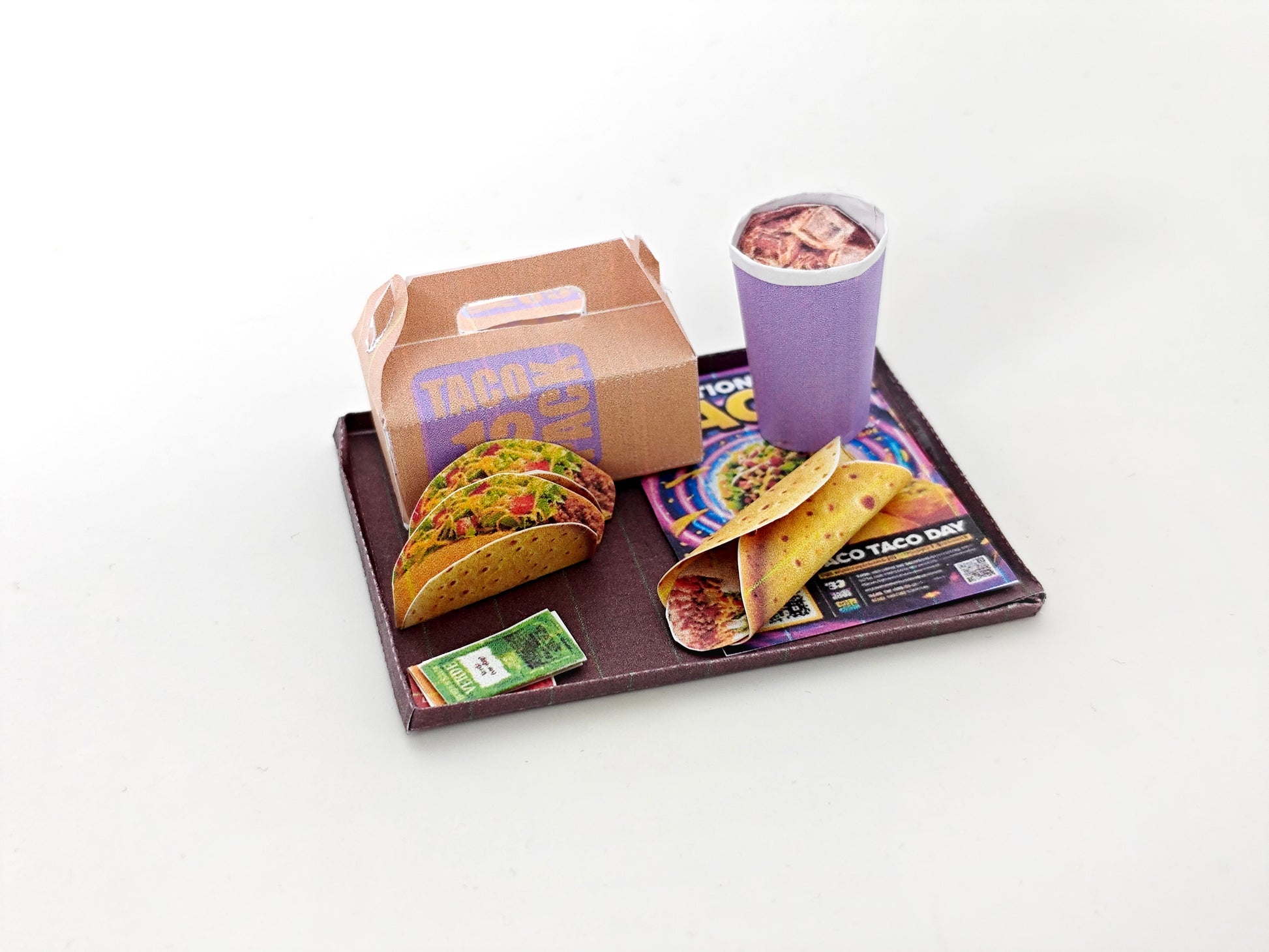 A 1:12 scale printable dollhouse fast food set featuring a taco wrap and soda, crafted as DIY templates for miniature dining scenes or yearly ornaments, ideal for detailed diorama customization.