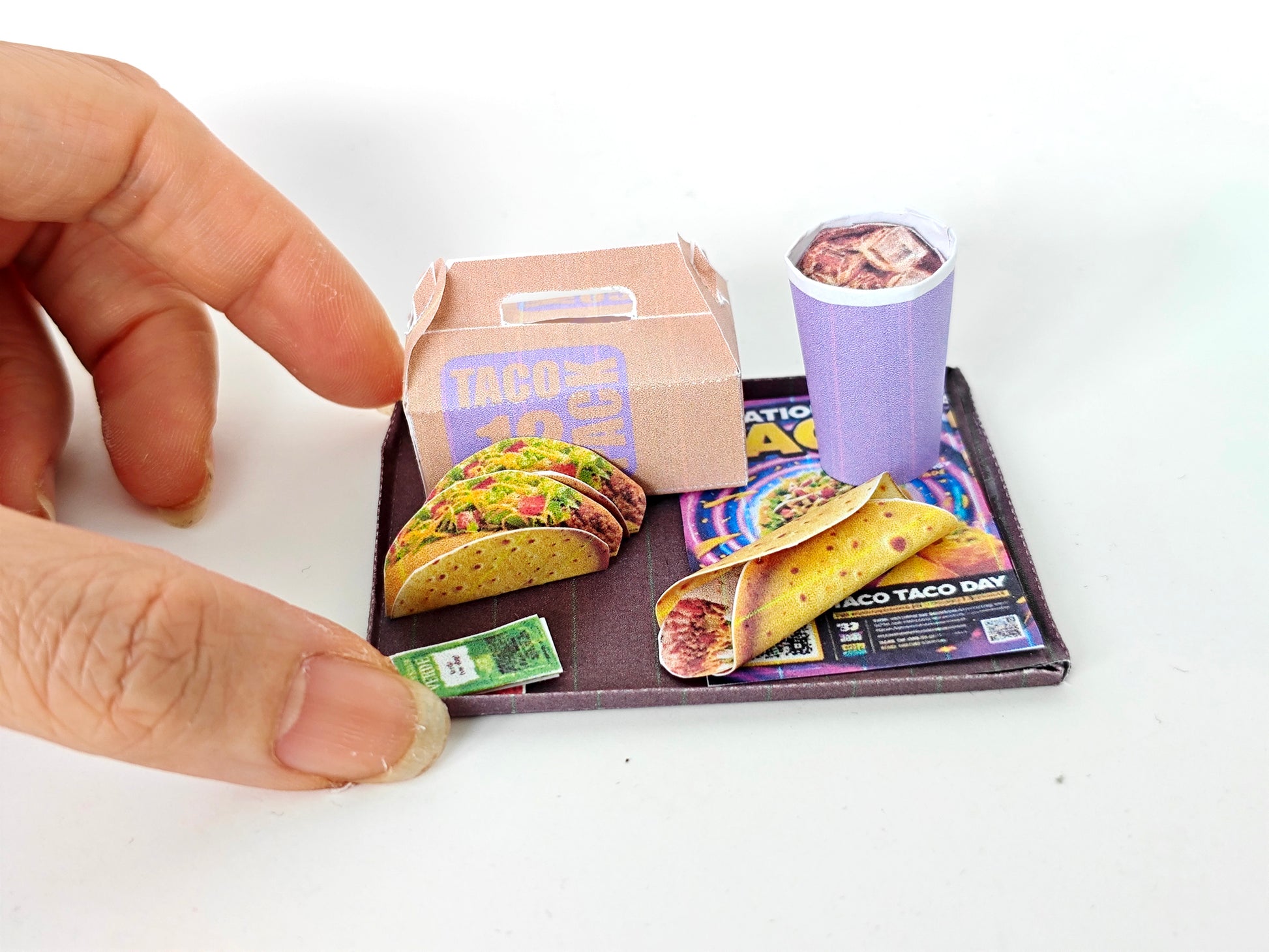 A 1:12 scale printable dollhouse fast food set featuring a taco wrap and soda, crafted as DIY templates for miniature dining scenes or yearly ornaments, ideal for detailed diorama customization.