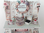 A 3D-printable STL file of a 1:12 scale vintage birthday stand DIY kit, featuring a detailed stand for displaying miniature birthday presents and cards in a dollhouse.