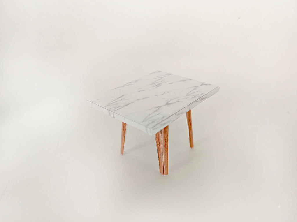 A 1:12 scale printable dollhouse furniture set from BMM Shoebox Miniature, featuring a dining table and chairs, crafted as DIY templates for a miniature living room or dining scene, ideal for diorama customization.