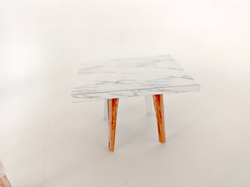 A 1:12 scale printable dollhouse furniture set from BMM Shoebox Miniature, featuring a dining table and chairs, crafted as DIY templates for a miniature living room or dining scene, ideal for diorama customization.