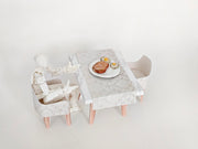 A 1:12 scale printable dollhouse furniture set from BMM Shoebox Miniature, featuring a dining table and chairs, crafted as DIY templates for a miniature living room or dining scene, ideal for diorama customization.