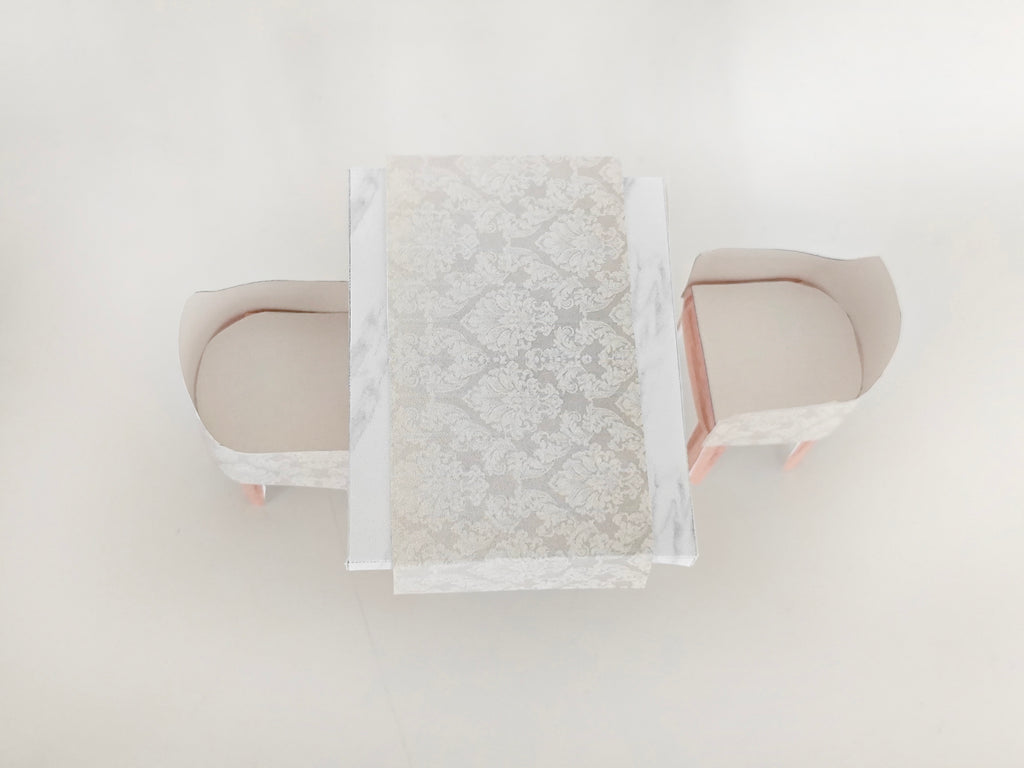 A 1:12 scale printable dollhouse furniture set from BMM Shoebox Miniature, featuring a dining table and chairs, crafted as DIY templates for a miniature living room or dining scene, ideal for diorama customization.