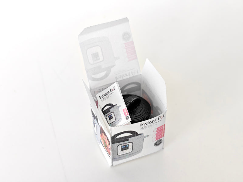 "A 3D-printable STL file of a 1:12 scale miniature Instant Pot, featuring detailed buttons and a lid for a realistic dollhouse kitchen appliance

