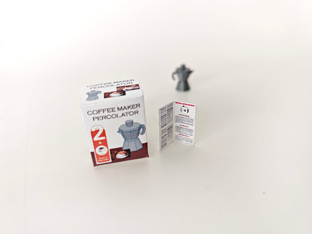 A 1:12 scale 3D-printed dollhouse coffee bar setup featuring a stove-top coffee maker, mini cookware, and a pot, with printable packaging and manual, arranged to create a detailed miniature kitchen or coffee scene for dollhouse decoration.