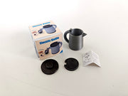 A 3D-printable STL file of a 1:12 scale miniature electric kettle with an openable lid, featuring detailed buttons and a spout for a realistic dollhouse kitchen.

