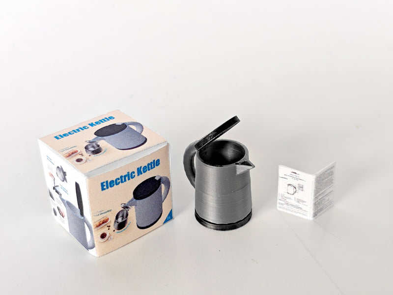 A 3D-printable STL file of a 1:12 scale miniature electric kettle with an openable lid, featuring detailed buttons and a spout for a realistic dollhouse kitchen.