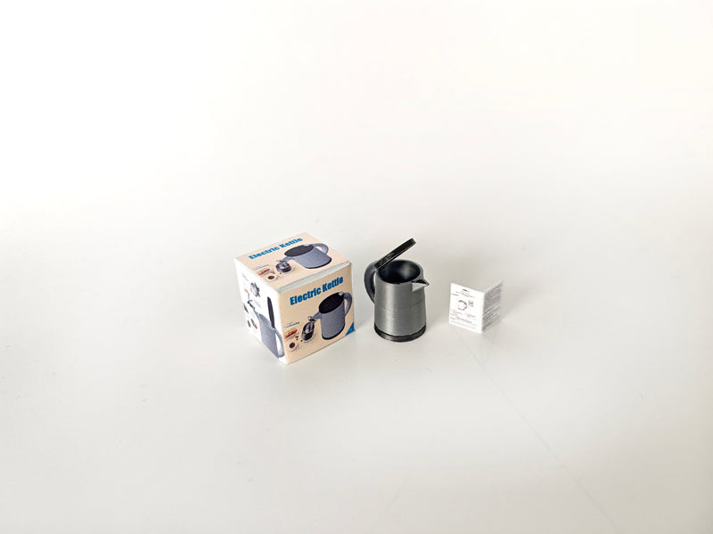 A 3D-printable STL file of a 1:12 scale miniature electric kettle with an openable lid, featuring detailed buttons and a spout for a realistic dollhouse kitchen.

