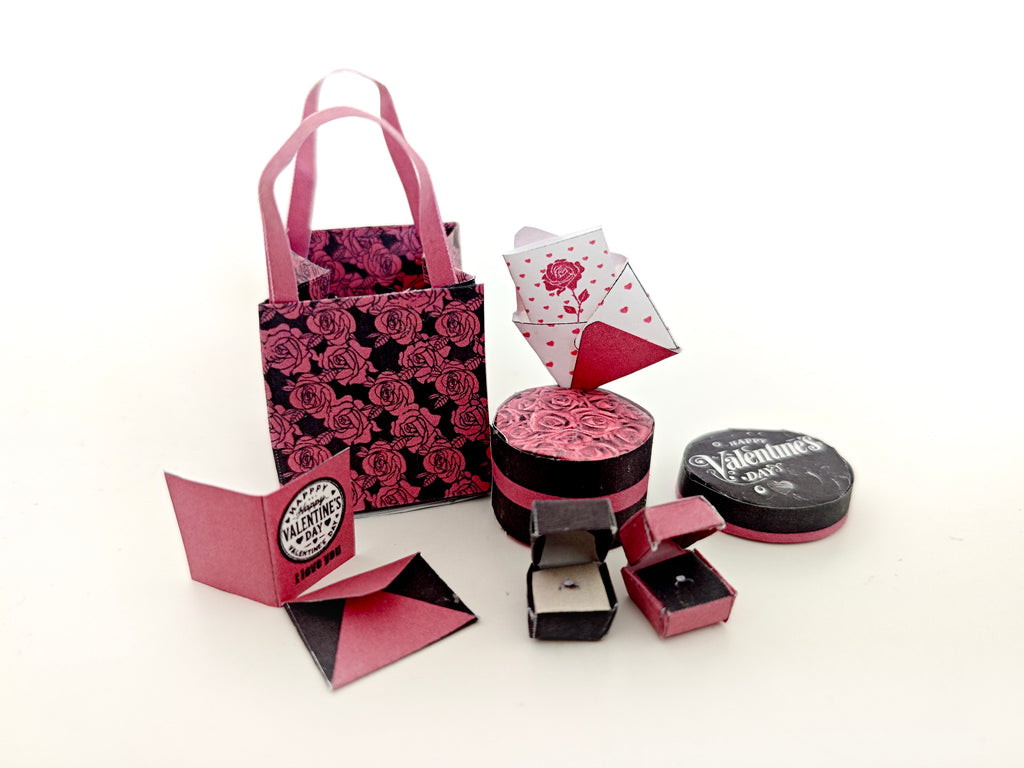 A 3D-printable STL file of a 1:6 scale Valentine’s Day gift set, featuring a flower gift box, romantic cards, rose bags, and an engagement ring, designed as charming dollhouse accessories for a miniature proposal scene or play scale display.
