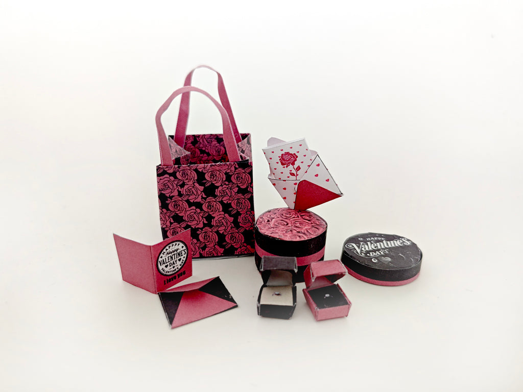 A 3D-printable STL file of a 1:6 scale Valentine’s Day gift set, featuring a flower gift box, romantic cards, rose bags, and an engagement ring, designed as charming dollhouse accessories for a miniature proposal scene or play scale display.

