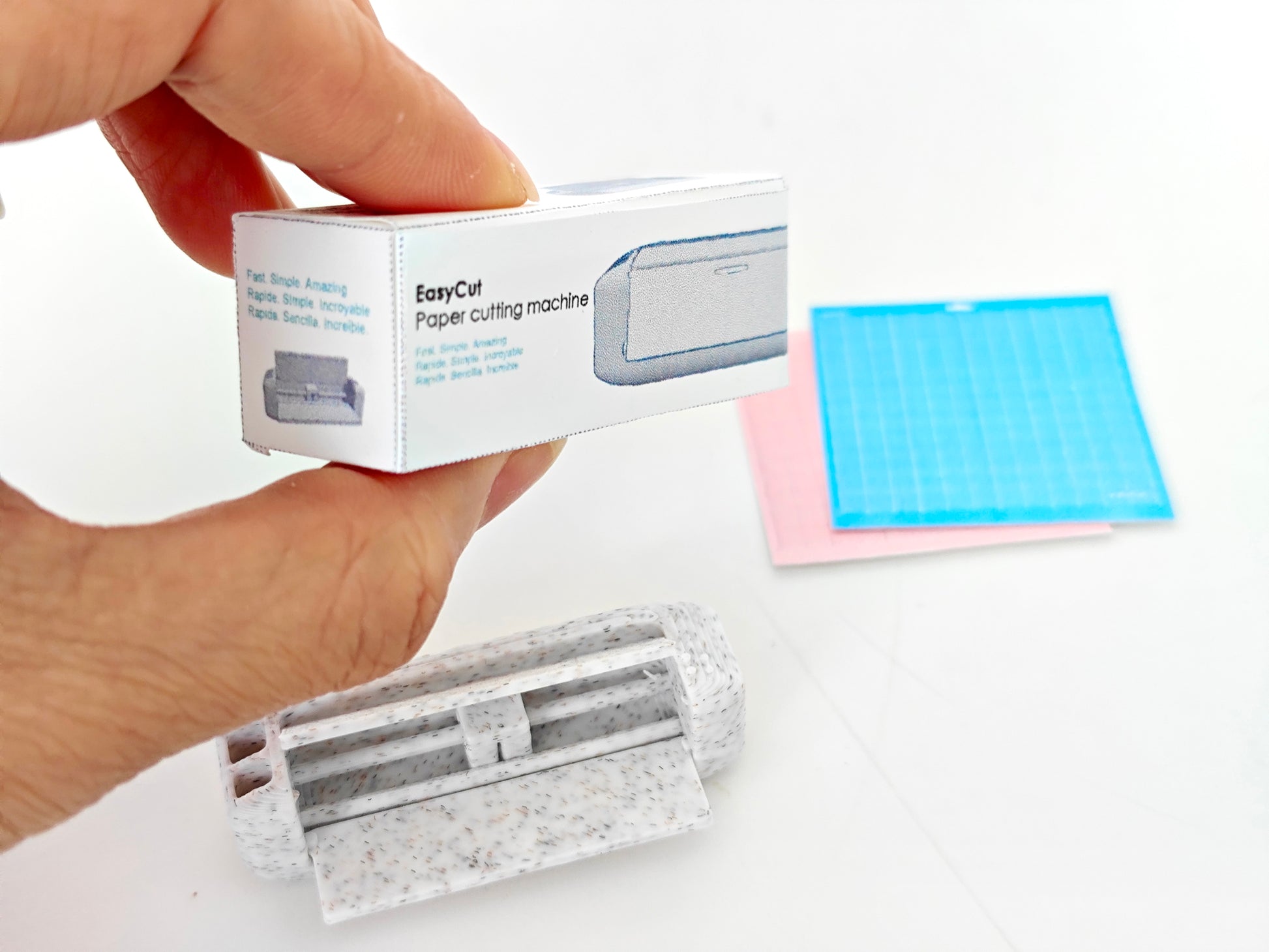 3D-rendered model of a 1:12 scale paper cutting machine with openable and movable parts, designed for 3D printing in STL format."


