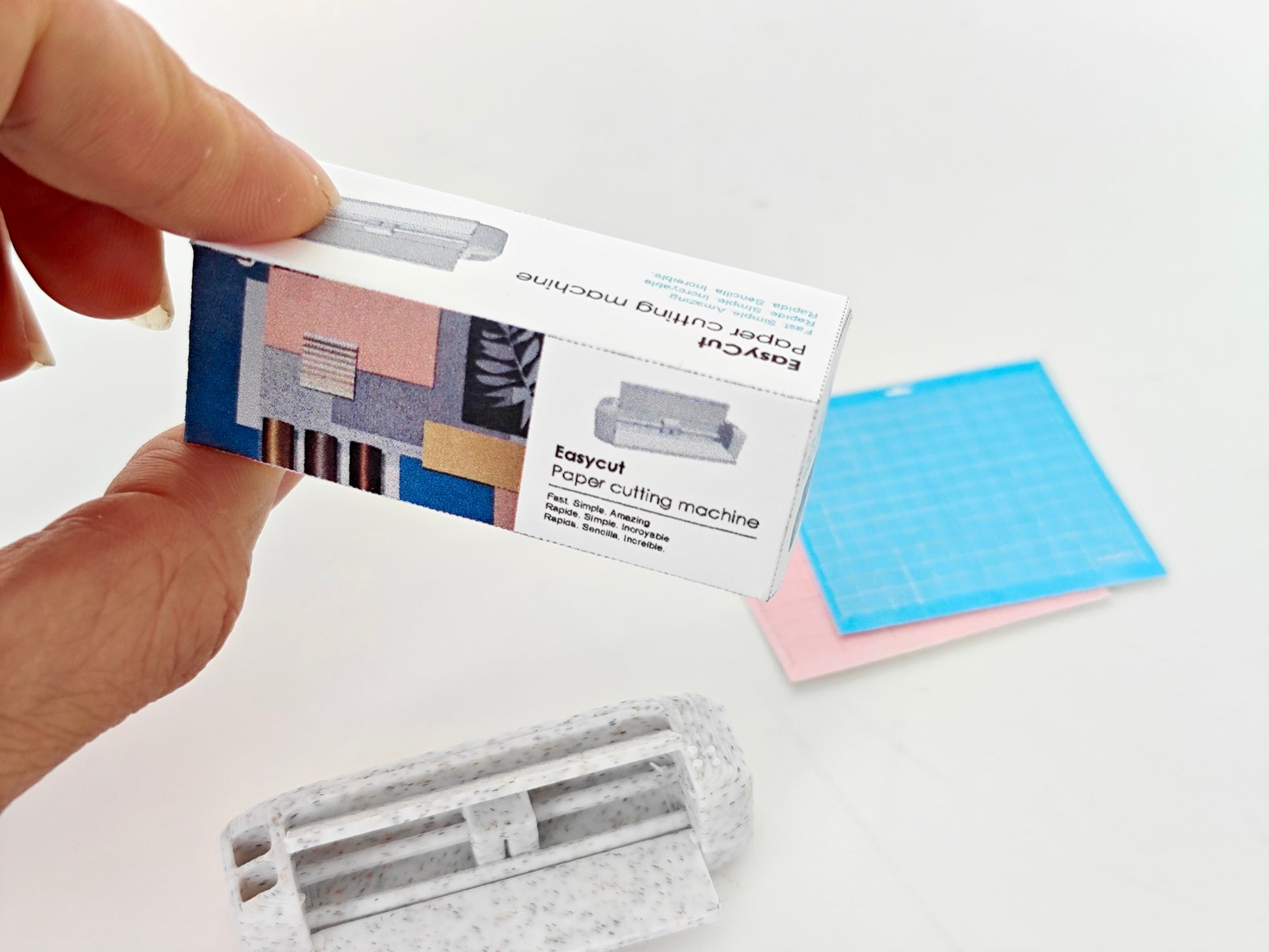 3D-rendered model of a 1:12 scale paper cutting machine with openable and movable parts, designed for 3D printing in STL format."

