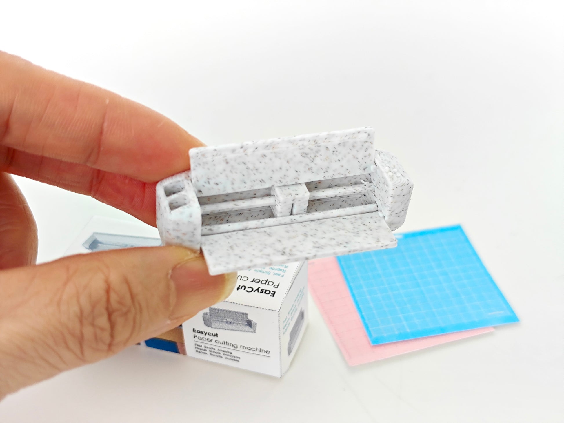 3D-rendered model of a 1:12 scale paper cutting machine with openable and movable parts, designed for 3D printing in STL format."

