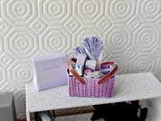 Discover our 1:12 scale lavender gift basket, a charming dollhouse hamper with 11 miniature items including teas, hand cream, soaps, scented fragrance bags, and candles—perfect for a tiny spa retreat