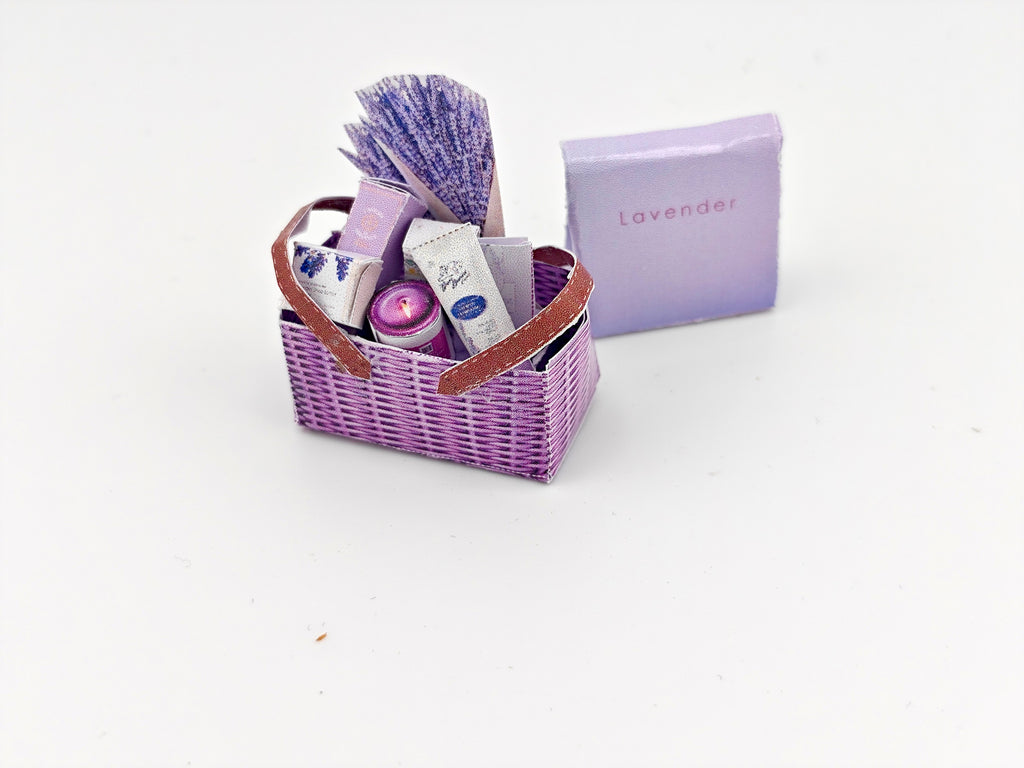 Discover our 1:12 scale lavender gift basket, a charming dollhouse hamper with 11 miniature items including teas, hand cream, soaps, scented fragrance bags, and candles—perfect for a tiny spa retreat