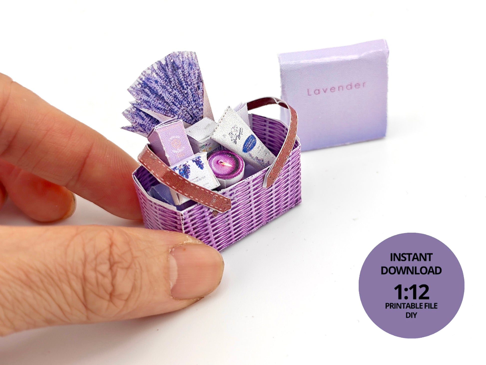 Discover our 1:12 scale lavender gift basket, a charming dollhouse hamper with 11 miniature items including teas, hand cream, soaps, scented fragrance bags, and candles—perfect for a tiny spa retreat