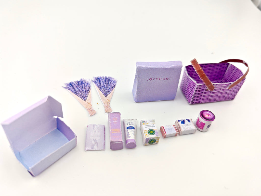 Discover our 1:12 scale lavender gift basket, a charming dollhouse hamper with 11 miniature items including teas, hand cream, soaps, scented fragrance bags, and candles—perfect for a tiny spa retreat
