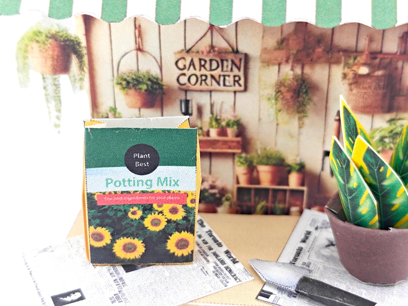 Discover the Garden Corner Miniature Stand: Create your own mini garden with plants, newspaper, potting mix, and pots. This miniature kit includes paper crafting supplies and a 7x5 frame for a charming, DIY display.