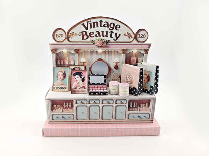 A digital image of a DIY vintage makeup counter miniature scenery kit made from cardstock. The kit features a foldable counter with a retro design, a small makeup box, a colorful poster with floral accents, and a detailed eyeshadow palette, arranged for a dollhouse display.