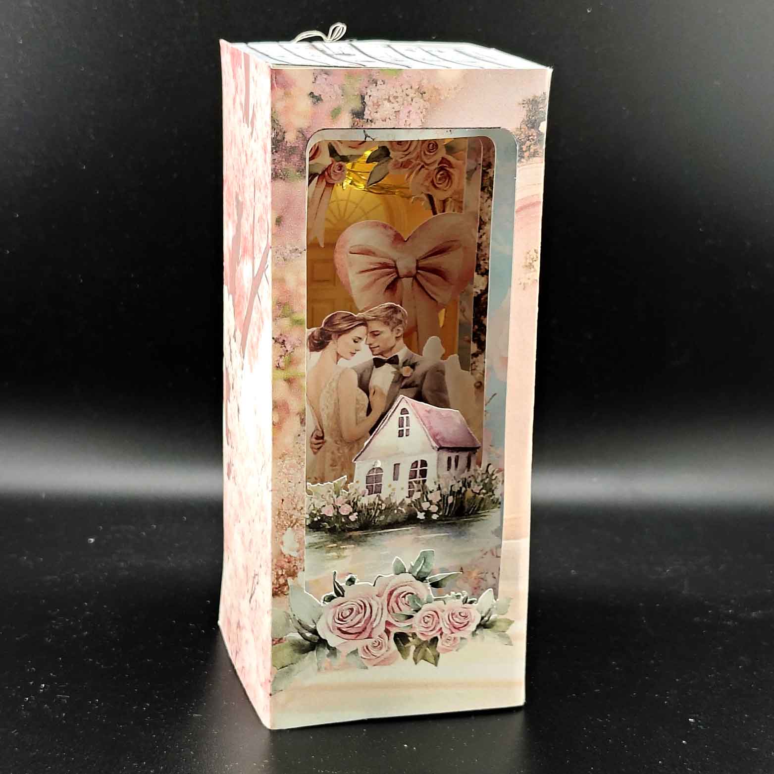 Bridal home book nook paper craft with wedding celebration scene, displayed inside a bookshelf