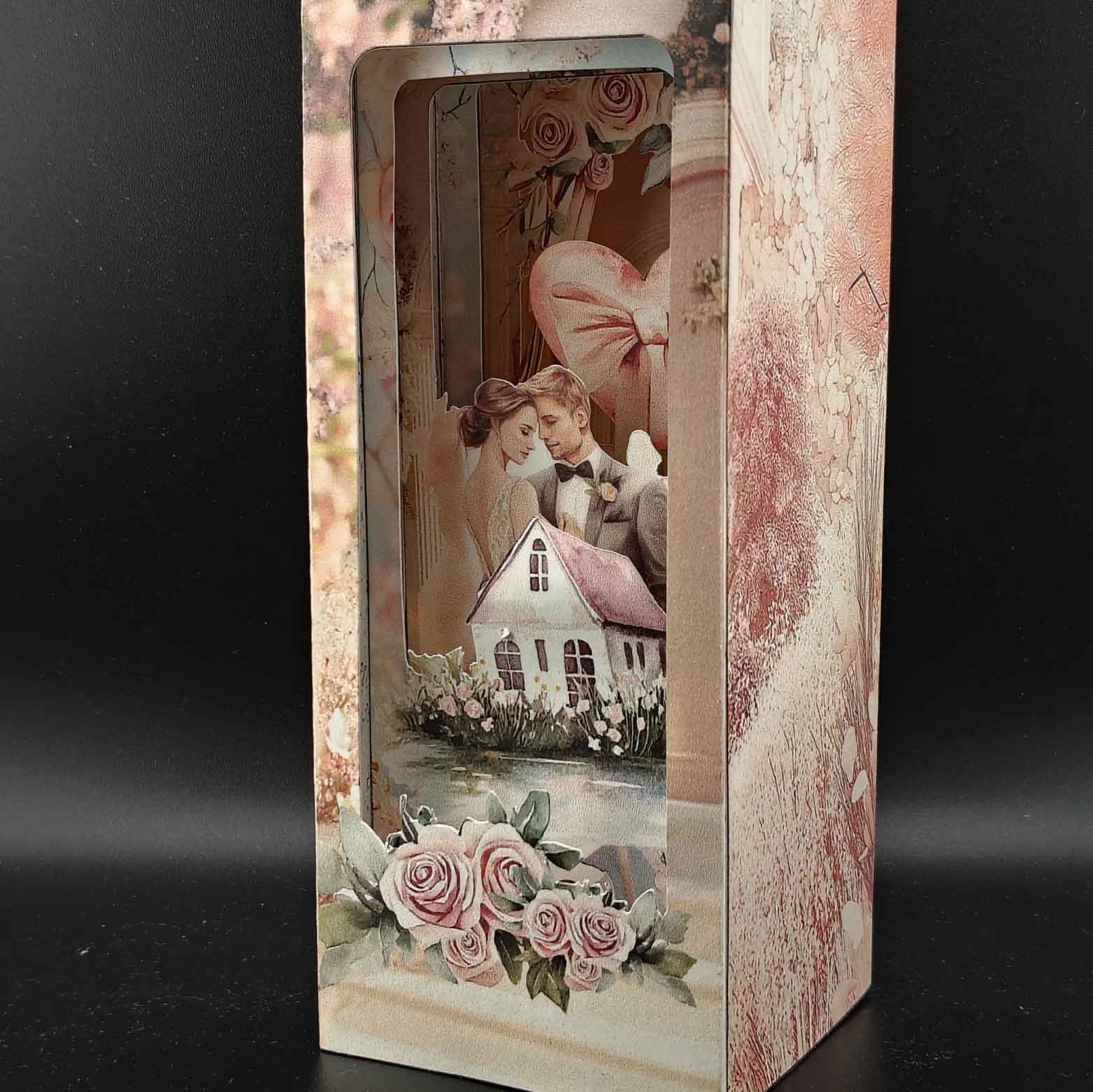 Bridal home book nook paper craft with wedding celebration scene, displayed inside a bookshelf