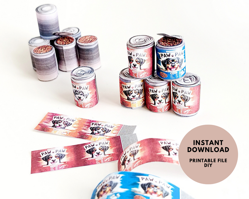 Miniature red and blue dog food cans and printable labels on a white surface.