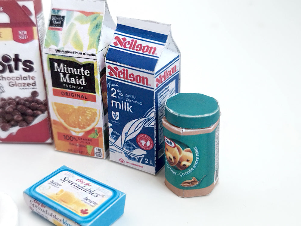 Start your doll’s day with this 1:6 scale 7-piece Miniature Breakfast Printable set! Featuring DIY mini boxes of milk, bread, pancakes, eggs, orange juice, cereal, and butter, it’s a must-have for miniature lovers and dollhouse enthusiasts.