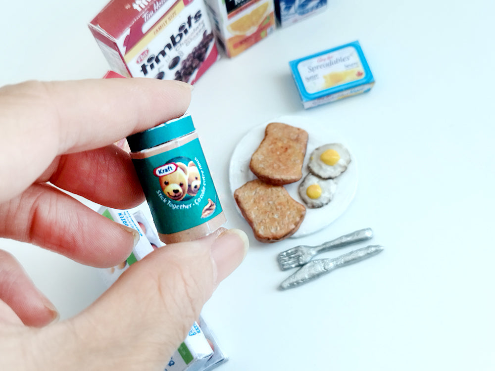 Start your doll’s day with this 1:6 scale 7-piece Miniature Breakfast Printable set! Featuring DIY mini boxes of milk, bread, pancakes, eggs, orange juice, cereal, and butter, it’s a must-have for miniature lovers and dollhouse enthusiasts.