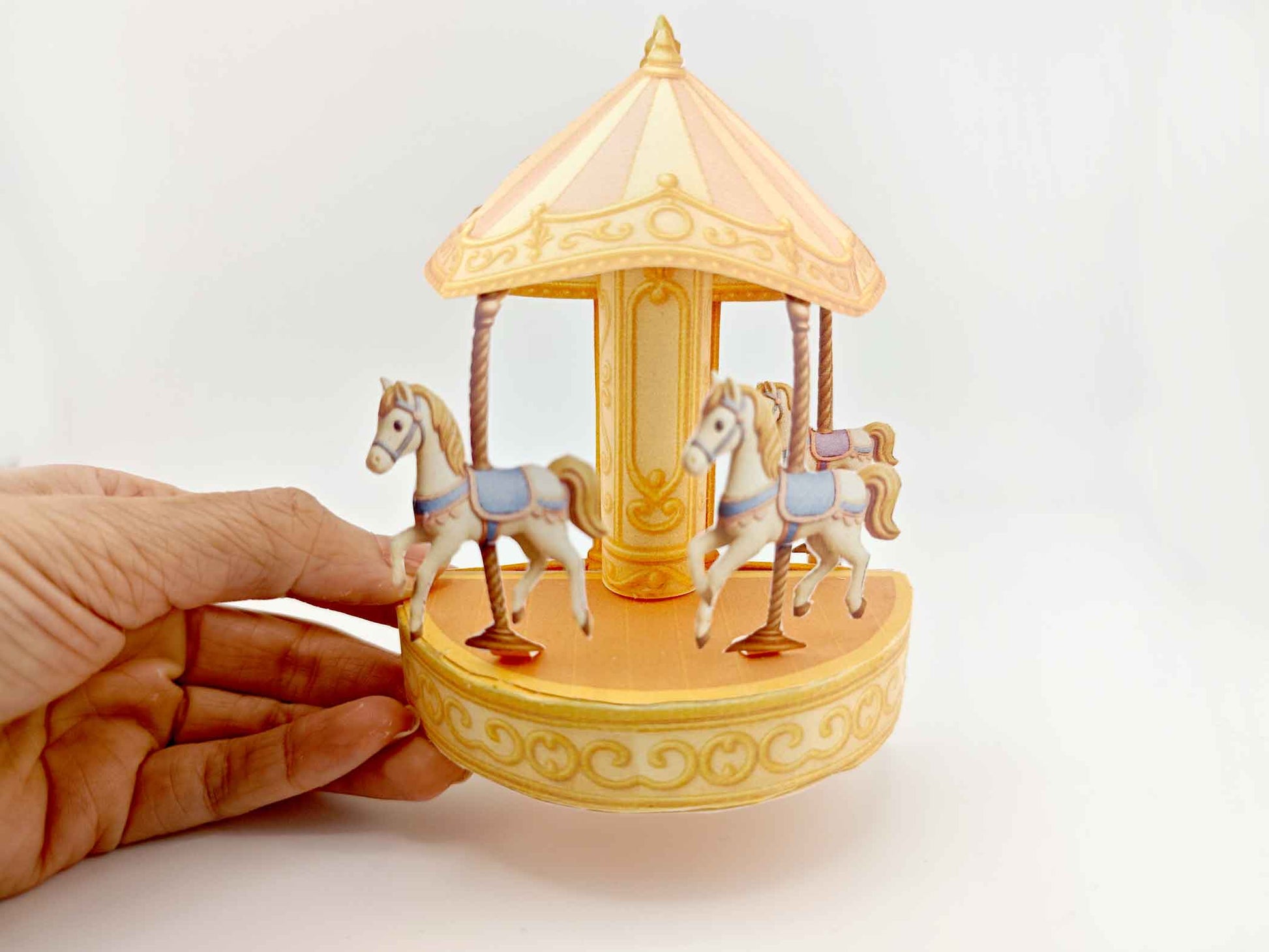 Fantasy-themed miniature scene with golden carousel