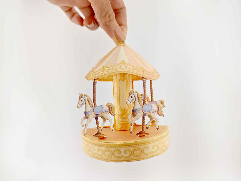 Fantasy-themed miniature scene with golden carousel