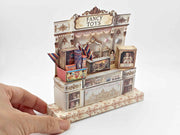 Vintage toy shop stand with miniature doll, robot, car, and fireworks, designed for collectible or dollhouse display