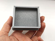 The most compelling miniature scenes rely on interactive, functional details that mirror the real world. This artist-crafted roof hatch features a fully working hinge design, allowing the textured protective lid to swing open or closed.